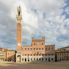 Daytime view of Palazzo Pubblico and Torre del Mangia in Piazza del Campo, Siena, Tuscany, Italy.