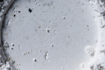 Detailed macro shot of white granular powder with fine textures and small lumps. Ideal for...