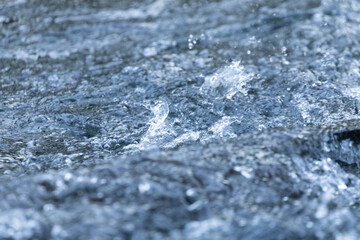 Water splashes in fast running flowing water