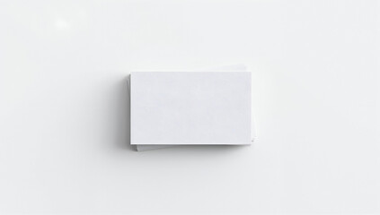 Blank white business cards stacked on a clean white surface, ready for design