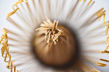 High-angle macro shot of a traditional Japanese bamboo matcha whisk, showing intricate details of the tines and central core. Ideal for tea ceremony and wellness content