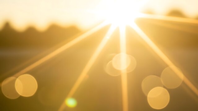 Bright light source with sun rays extending outward, creating lens flare. Soft bokeh effect in the background with gentle rainbow-colored highlights, suggesting sunlight.