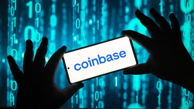 Hands holding smartphone with Coinbase app on screen