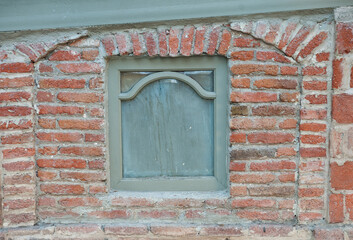 Brick window facade shows rustic masonry texture
