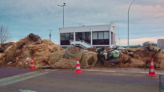 Semur-en-Auxois, FRANCE - JANUARY 16, 2026: Agricultural debris and soil cleared from A6 highway exit 23 following French farmers' protest. Road access restored after blockade at toll booth.
