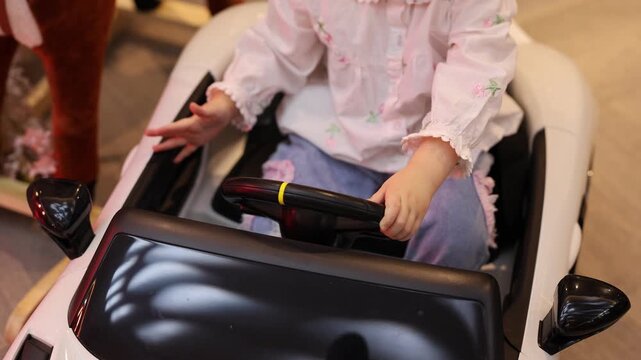 Child drives toy car, Child explores with toy car indoors effortlessly