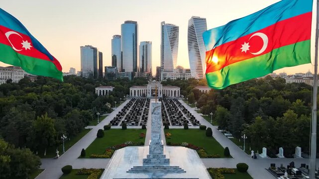 Azerbaijan Flags Fly in Front of Modern Skyline and Memorial Park in Baku at Sunset