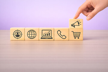 Omnichannel marketing and customer engagement concept with communication and shopping icons on blocks