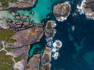 Top-down view of granite boulders and turquoise coastal pools © Stephen