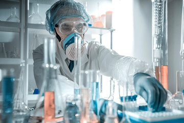 Pharmaceutical scientist wearing a white lab coat and protective mask in a laboratory. Concept of drug research and development, pharmaceutical standards, laboratory analysis expertise.