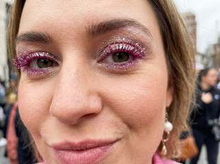 Close up portrait of a woman with a pink glittery trendy makeup 