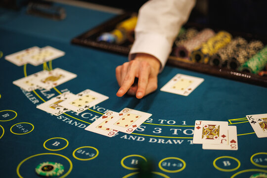 Casino Dealer Dealing Cards at Poker Table with Chips