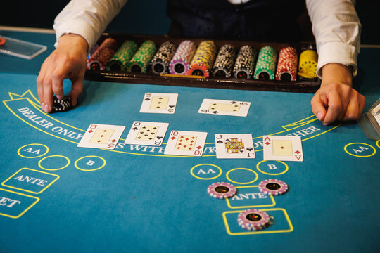 Casino Dealer Dealing Cards at Poker Table with Chips