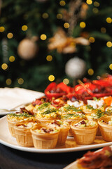 Festive Canap&eacute;s in Waffle Cups on Holiday Buffet with Christmas Bokeh