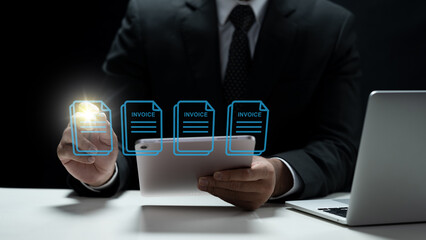 A professional businessman in a suit uses a tablet to manage electronic invoices, representing digital billing, accounting software, and paperless office technology
