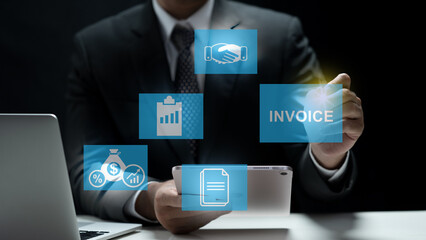 A professional businessman interacts with a digital interface on a tablet, managing invoices, financial reports, and business partnerships through holographic icons in a dark office