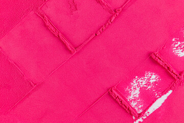 Abstract cosmetic background in bright crimson color with a pattern. The texture of the crushed powder of a pink blush. top view. Layout for design