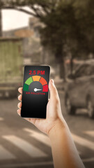 A person uses a smartphone app to measure dangerous PM 2.5 air pollution levels in a hazy, traffic-heavy city. Concept for environmental monitoring, urban health, and smart technology