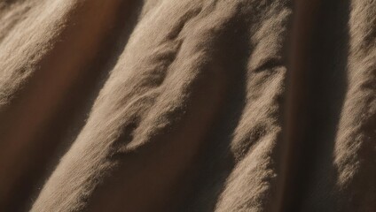 Close-up of soft, textured fabric with flowing lines and subtle shading, evoking warmth