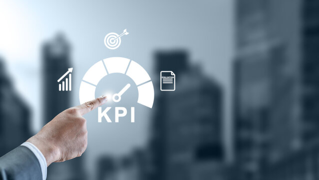 Hand touching a digital KPI gauge interface with performance indicators like growth charts and goal targets over a blurred city background. Concept for business evaluation and success tracking - Powered by Adobe