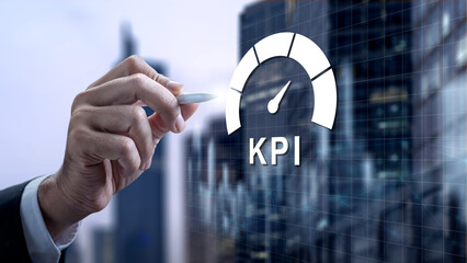 Businessman hand using a digital stylus to monitor Key Performance Indicators on a virtual dashboard with a corporate city background for data analysis and strategy tracking