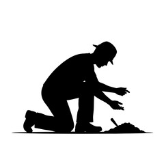 Obraz premium Silhouette of a man kneeling and working with soil outdoors.