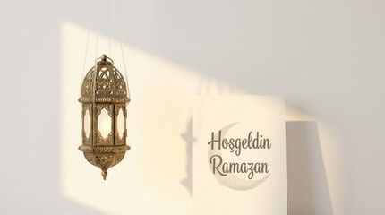 Ramadan kareem A card displays an ornate lantern illustration and some text against a soft white surface with gentle shadows falling across it