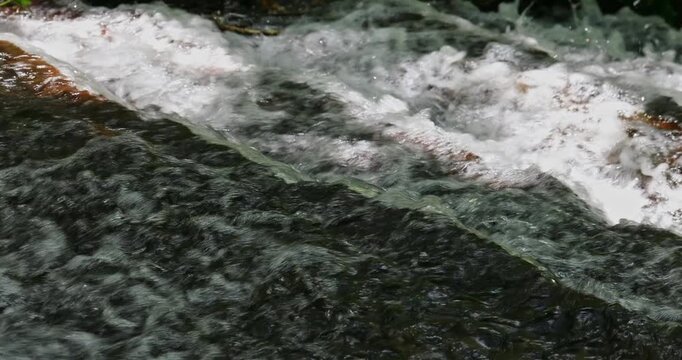 The babbling brook flows over the rocks