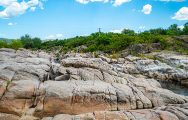 A rocky landscape with a blue sky in the background
