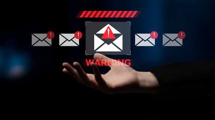 A hand reaches out towards a digital warning icon representing email alerts, capturing themes of cybersecurity, caution, and the need for vigilance in a connected world. Gantry