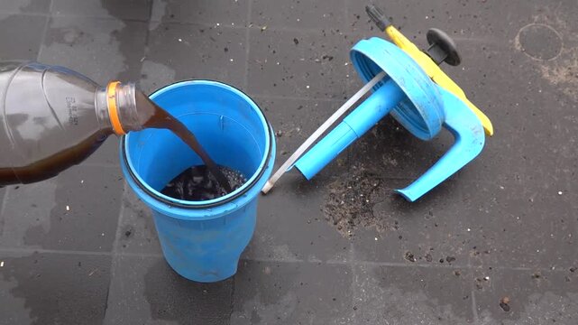 man fills sprayer with insecticide or fertilizer for the vegetable garden, for spraying plants.