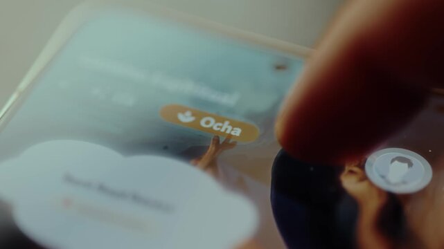 Person taps the button Ocha on smartphone screen with finger