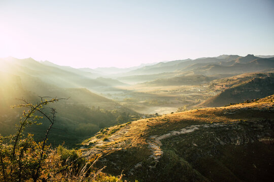 Golden Sunrise Over Misty Drakensberg Valley in South Africa
