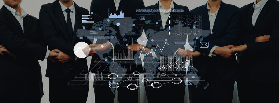 A group of business professionals in suits standing confidently, with an overlay of digital graphics representing a world map and financial statistics. Trope - Powered by Adobe