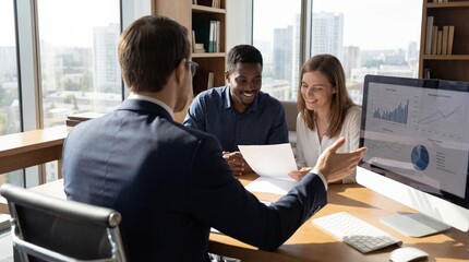 Business team discussing data on computer in modern office