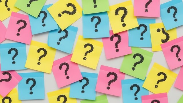 Vibrant collection of colorful sticky notes with black question marks scattered on a surface - Powered by Adobe