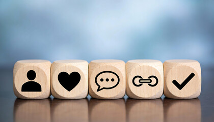 Five wooden cubes with profile heart chat link and check icons representing social media engagement communication networking verified account and online community on blue background