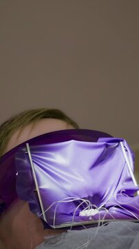 A person engages in a whimsical moment, wearing bright, shiny clothing, surrounded by colorful decor, sparking curiosity and joy in a lively atmosphere.