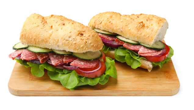 Tasty baguette sandwiches with cucumber, sausage, onion, tomato and lettuce isolated on white