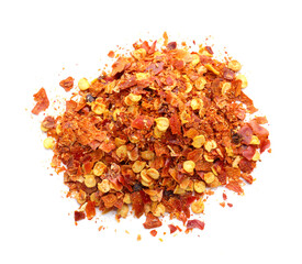 Pile of red chili flakes isolated on white, top view