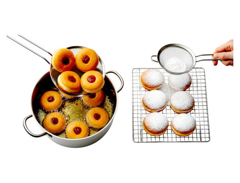 Homemade jelly-filled doughnuts are deep-fried in a pot of hot oil and then dusted with powdered sugar using a sifter on a wire cooling rack in a top-down view