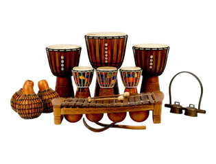 Traditional African percussion instruments including djembe drums, a wooden balafon, beaded shekere, and a metal bell in a cultural music ensemble arrangement
