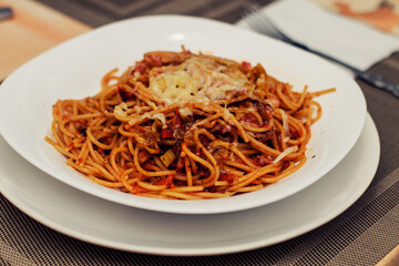 Spaghetti pasta with tomato sauce, cheese, and vegetables