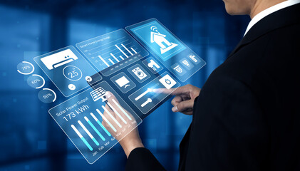 A business professional engages with a digital interface showcasing smart technology and data analytics, emphasizing innovation and connectivity in modern homes. Gantry