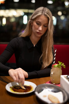 young woman eating a meal in the restaurant