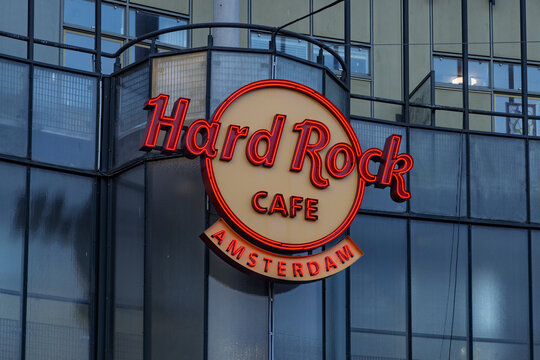 The iconic neon logo sign of the Hard Rock Cafe restaurant and bar located on the facade at the Max Euweplein square. Amsterdam Netherlands, 28 december 2025
