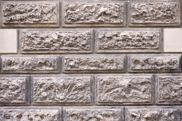 Structured stone brick wall with rectangular masonry pattern
