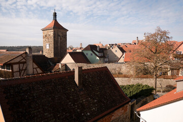 Old town rooftops with stone tower and traditional buildings
