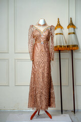 Elegant Bronze Sequin Wedding Gown or Modern Kebaya on Mannequin