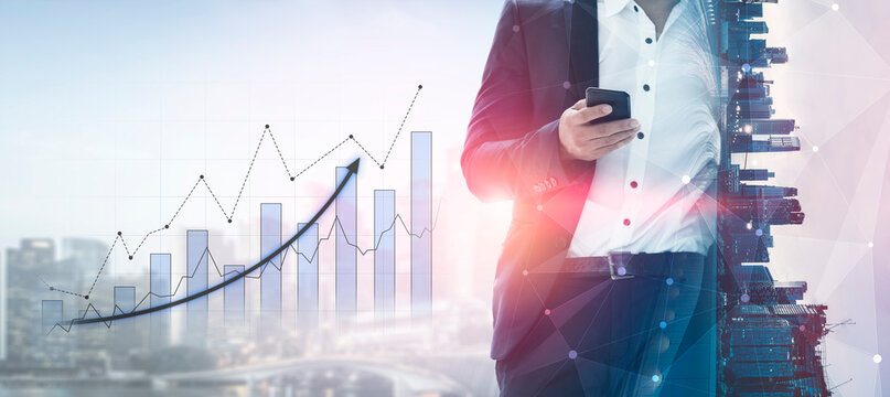 A businessman holding a smartphone stands against a modern city skyline, showcasing a financial growth chart that symbolizes success and innovation in business strategies. Scalp - Powered by Adobe